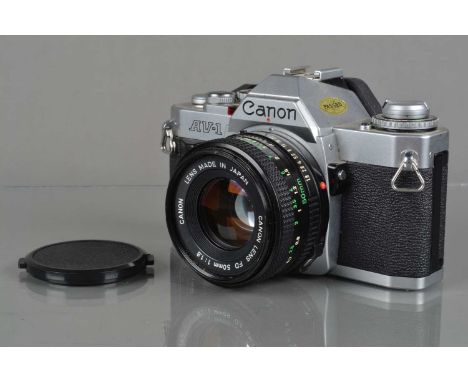 A Canon AV-1 SLR Camera, chrome, shutter working, meter/camera responsive, self timer working, body G-VG, with 50mm f/1.8 len