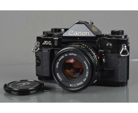 A Canon A-1 SLR Camera, black, shutter working, meter responsive, self timer working, viewfinder display working, body G, wit