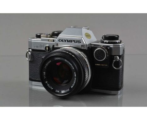 An Olympus OM-10 SLR Camera, shutter working/responsive, meter responsive, self timer working, body G, with manual adapter, Z