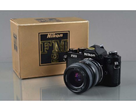 A Nikon FM2 SLR Camera, black, serial no N 7502635, shutter working, meter responsive, self timer working, body VG, with Tamr