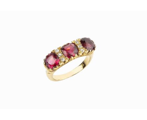 A red spinel and diamond half hoop ring, the scroll decorated hoop inset with three cushion-shaped mixed-cut red spinels, spa