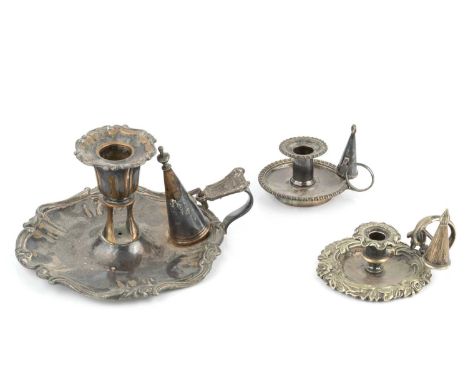 A 19th century Sheffield plate chamberstick, with snuffer, four further smaller plated chambersticks, a white metal model of 