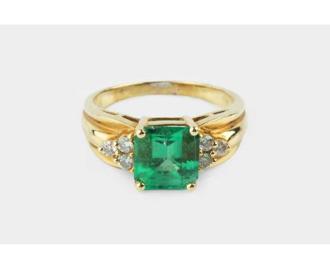 An emerald and diamond dress ring, the square step-cut emerald with canted corners, measuring approximately 8.7mm length x 8.