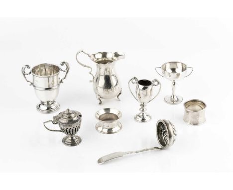 A collection of silver, comprising a baluster cream jug, London 1945, three small twin handled trophy cups, an oil lamp, two 