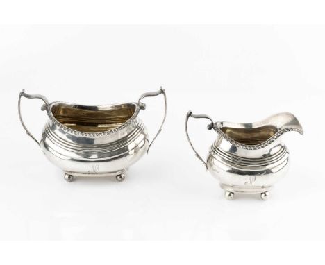 A silver twin handled sucrier and matching milk jug, with gadrooned borders, on ball feet, by Nathan &amp; Hayes, Chester 191