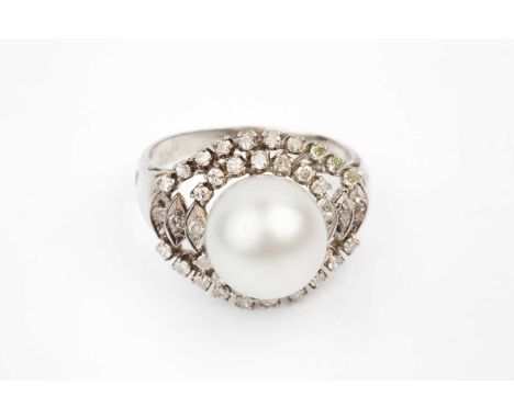 A cultured pearl and diamond ring, the cultured pearl measuring approximately 11mm diameter, bordered by a tiered cluster of 