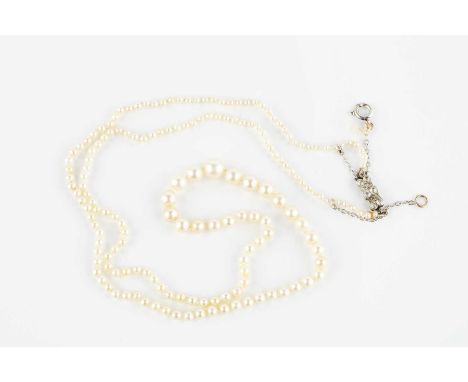 A pearl necklace with diamond set clasp, the single strand of graduated pearls measuring approximately 5.3mm to 1.6mm in diam