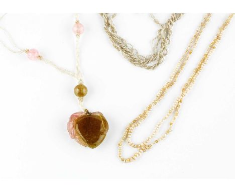 Three pearl necklaces, comprising a seed pearl triple strand necklace, suspending a carved watermelon tourmaline pendant, wit
