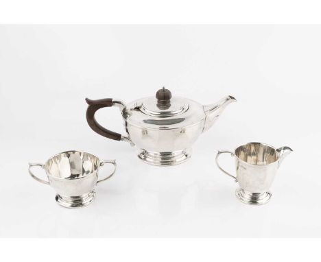 A silver three piece tea service, of faceted circular design, the teapot with composition handle and knop, by Mappin &amp; We