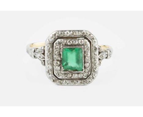 An early 20th century diamond set panel ring, centred with a rectangular step-cut green stone (chipped) in collet setting, wi