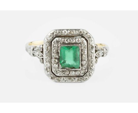 An early 20th century diamond set panel ring, centred with a rectangular step-cut green stone (chipped) in collet setting, wi