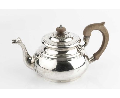 A silver teapot, with raised stylised leaf decoration to the lid and spout, and having composition handle, by Garrard &amp; C