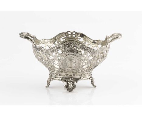 A Continental late 19th century silver twin handled small basket, the trellis pierced sides decorated with swags and portrait