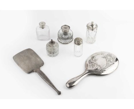 An Edwardian silver backed hand mirror, embossed with Art Nouveau style sinuous flowers, by William Neale, Chester 1905, anot