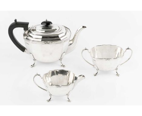 A silver three piece tea service, of faceted design, the teapot with ebonised handle and knop, by George Wish &amp; Co Ltd, S