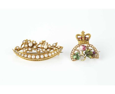A commemorative enamel and half pearl panel brooch, modelled as a polychrome enamel shamrock, rose and thistle spray, surmoun