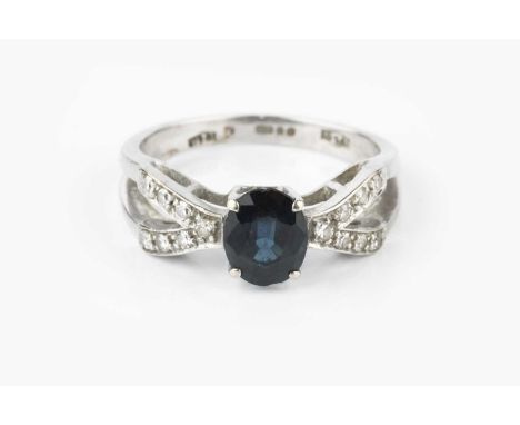 A sapphire and diamond dress ring, the oval mixed-cut sapphire claw set between wishbone-shaped shoulders of single-cut diamo