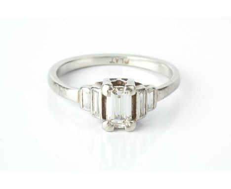 A diamond five stone ring, the graduated baguette-cut diamonds in stepped setting, white precious metal mounted, stamped 'PLA