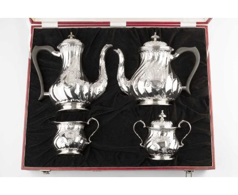 A silver four piece tea and coffee service, of spirally fluted baluster design, the tea and coffee pots with composite handle