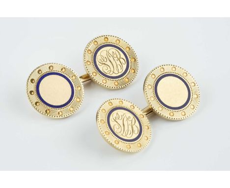 A pair of enamel cufflinks, each circular panel with engraved reeded and beaded borders, edged by blue enamel, on chain and b