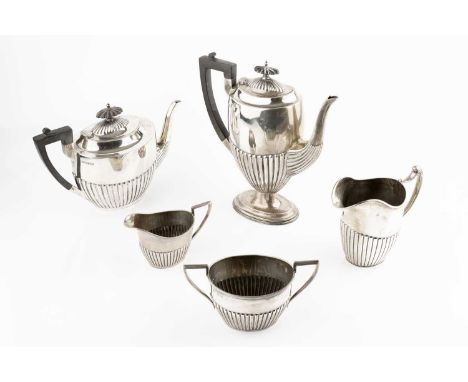 A silver four piece tea and coffee service, with half lobed decoration, the tea and coffee pots with ebonised handles and kno