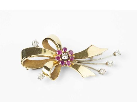 A ruby and diamond spray brooch, modelled as an openwork tied ribbon, centred with a cluster of circular mixed-cut rubies enc