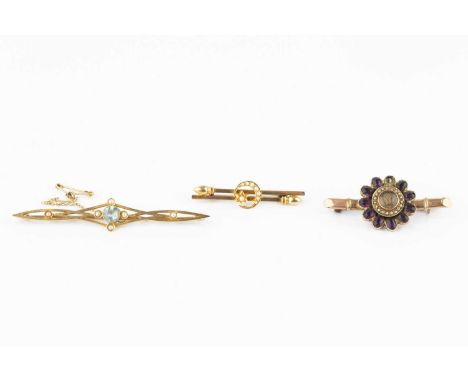 A late Victorian/Edwardian half pearl set bar brooch, designed as two obliquely positioned bars, applied with a half pearl se