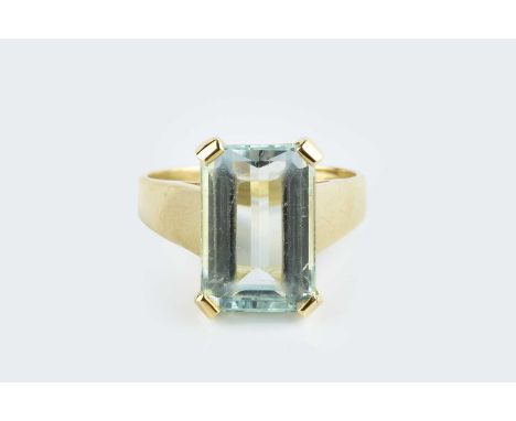 An aquamarine single stone ring, the rectangular step-cut aquamarine with canted corners, in four claw setting, to a tapered 