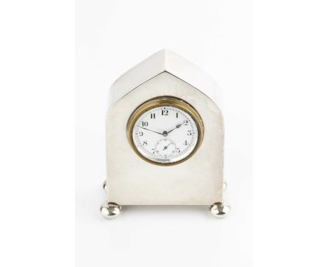 A silver cased small mantel timepiece, with white enamel dial having seconds subsidiary dial, the case with arched top and bu
