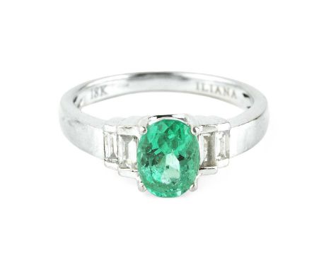 An emerald and diamond dress ring, the oval mixed-cut emerald claw set between stepped shoulders of baguette-cut diamonds, 18