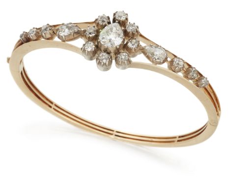 A 19th century gold and silver diamond bangle, of hinged knife edge bar design, centering on a cluster of old-pear-cut and br