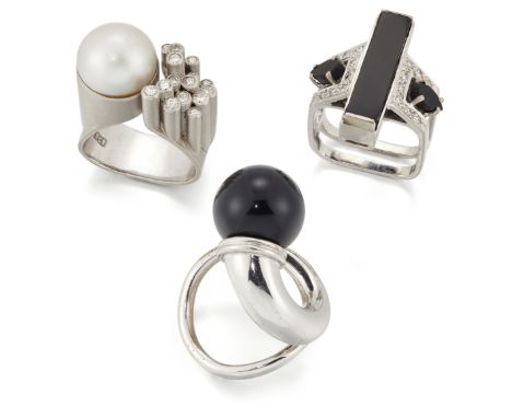 Three rings, comprising: an 18ct white gold onyx and diamond ring, by Alan Martin Gard, London hallmarks, 1976, maker's mark;