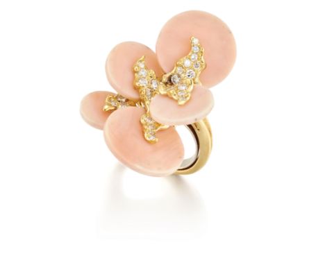 A coral and diamond ring, coral discs with brilliant-cut diamond set foliate claws, to a two row hoop, length of head 3.8cm, 