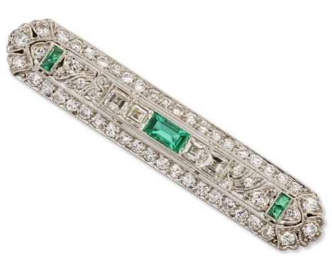 An early 20th century platinum, emerald and diamond brooch, the central baguette cut emerald with pairs of asscher cut diamon