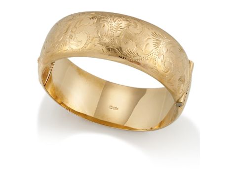 A 9ct gold bangle, of broad hinged design, the front section with foliate engraved decoration, London hallmarks, 1978, inner 