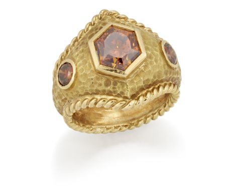 A coloured diamond three stone ring, the hexagonal mixed-cut fancy brownish orange diamond, with brilliant-cut brown diamond 