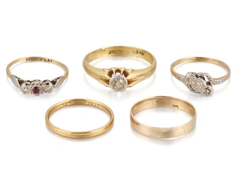 A group of five rings, comprising: a gold single stone diamond ring, stamped 18CT&PLAT, ring size W½; a gold three stone diam