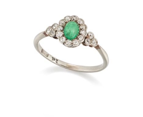 An early 20th century emerald and diamond cluster ring, the oval cabochon emerald to surround of old-single-cut diamonds, wit