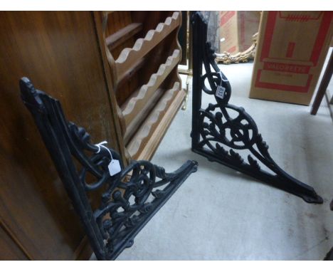A pair of  vintage ornate brackets and a small vice