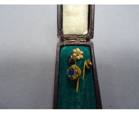 Four 19th / Early 20th century Yellow Metal Stick Pins, one marked 9ct with seed pearls and peridot