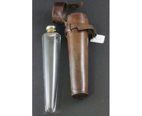 An early 20th century glass flask with silver plated top of tapering form in a leather holder 