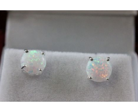 A paid of silver and opal stud earrings