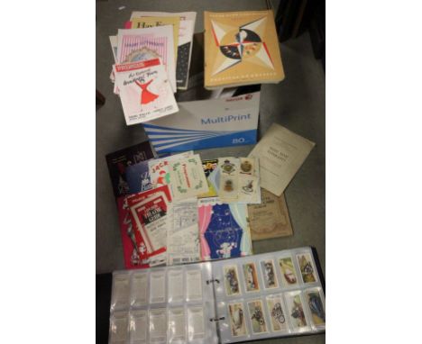 Box containing cigarette cards in albums with vintage theatre programmes