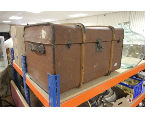 Large invincible leather and wood bound travelling trunk with selection of fabrics, Indian Sari, etc
