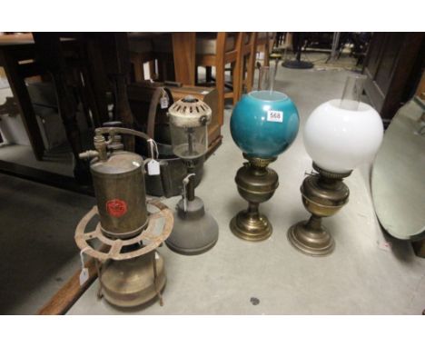 Three vintage oil lamps with shades, primus stove and blow torch