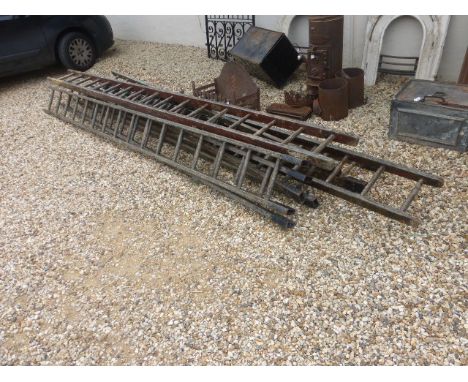 A quantity of vintage steeple jack ladders.