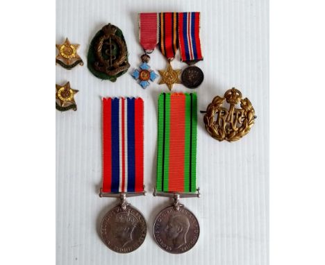 A WW2 Defence & War Medals and dress trio comprising Empire, Burma and 1939-1945 medals, RAF and Medical cap badges 