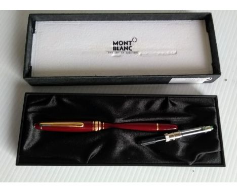 A  cased MontBlanc Meisterstuck fountain pen in burgundy and gold, numbered FC135890 with medium 14k nib (inked) and cartridg