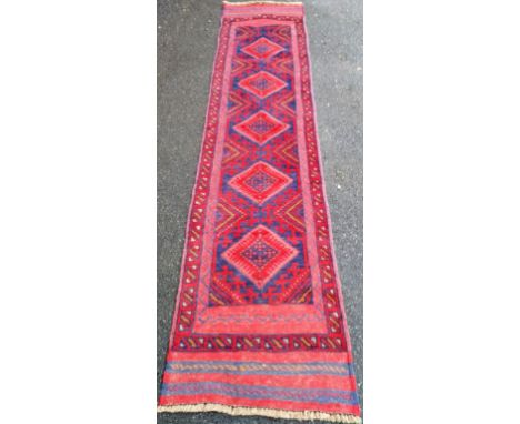An Afghan hand-knotted blue-ground Meshwani wool runner with multi-coloured isometric decoration, 61 x 262 cm in good conditi