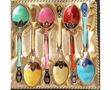 A cased set of six silver and enamel decorated coffee spoons, possibly Egyptian. Condition: enamel worn on bowl of yellow spo
